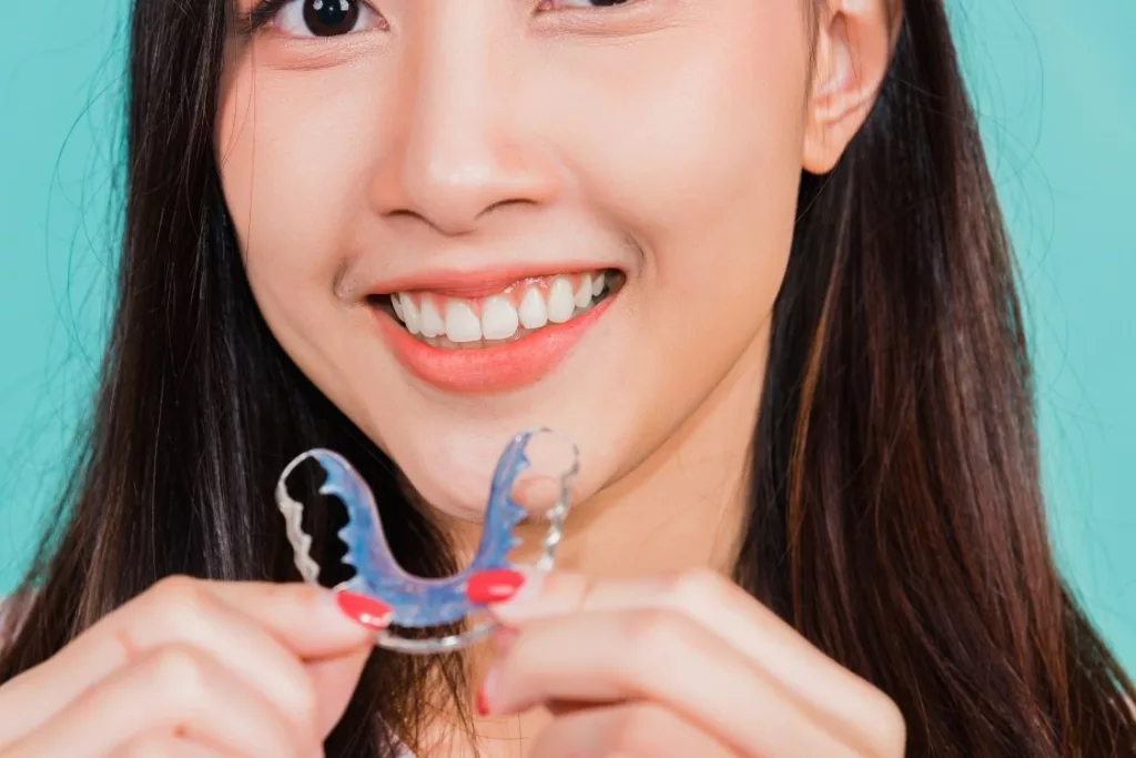 girl holding teeth whitening tray